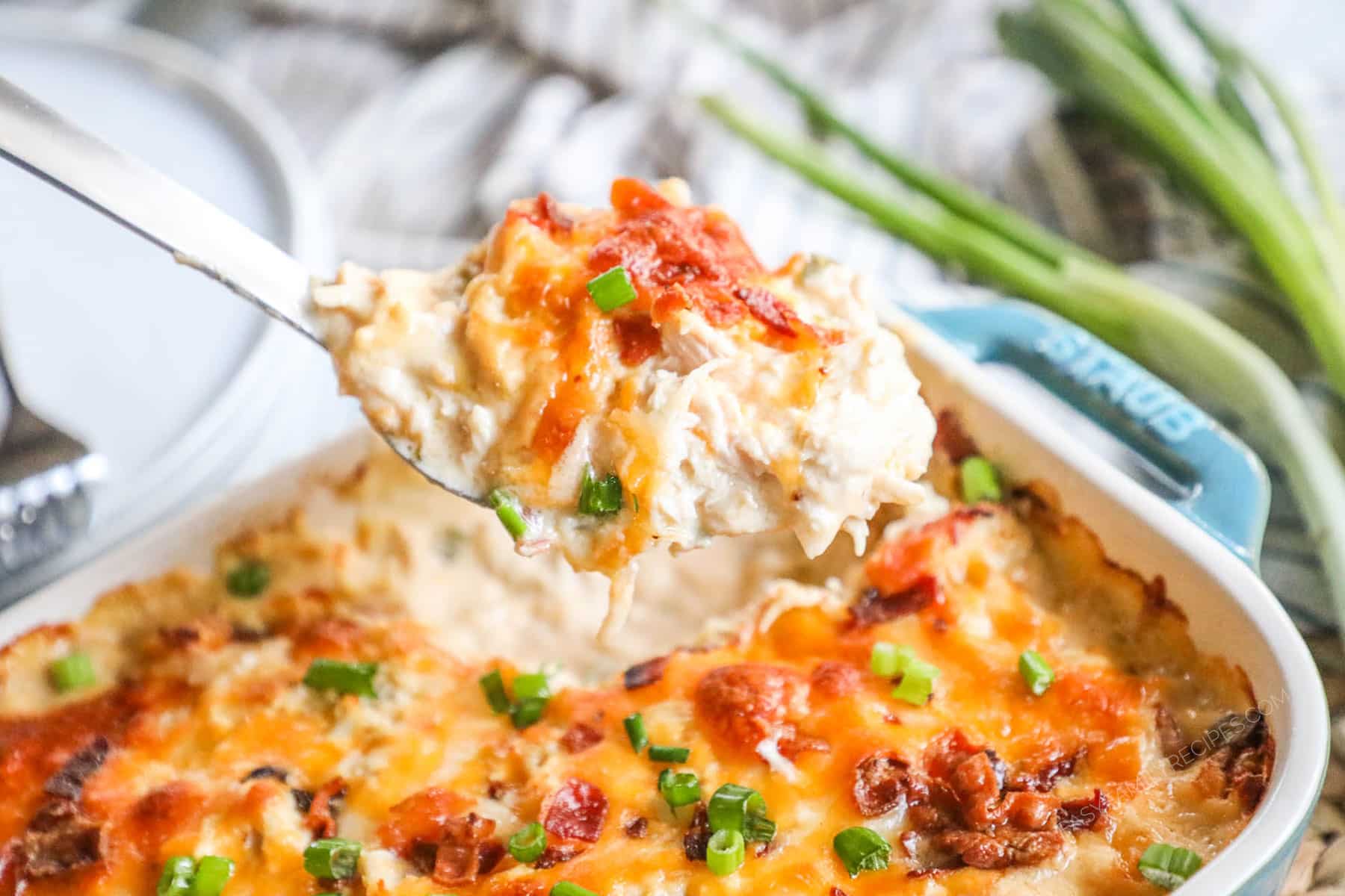 Million Dollar Chicken Casserole being scooped out of the baking dish