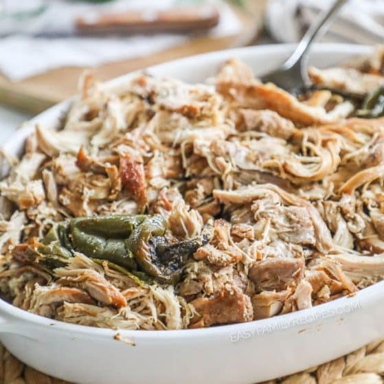 a white dish filled with shredded chicken carnitas