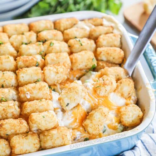 overhead of a blue casserole dish with baked tater tot casserole.