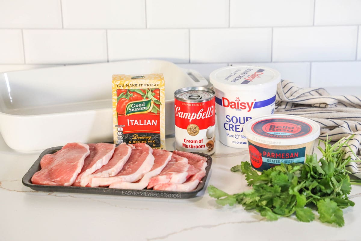 Ingredients for recipe before being prepped: thin boneless pork chops, Italian dressing dry mix, campbell's cream of mushroom soup can, sour cream, grated parmesan, and fresh parsley.