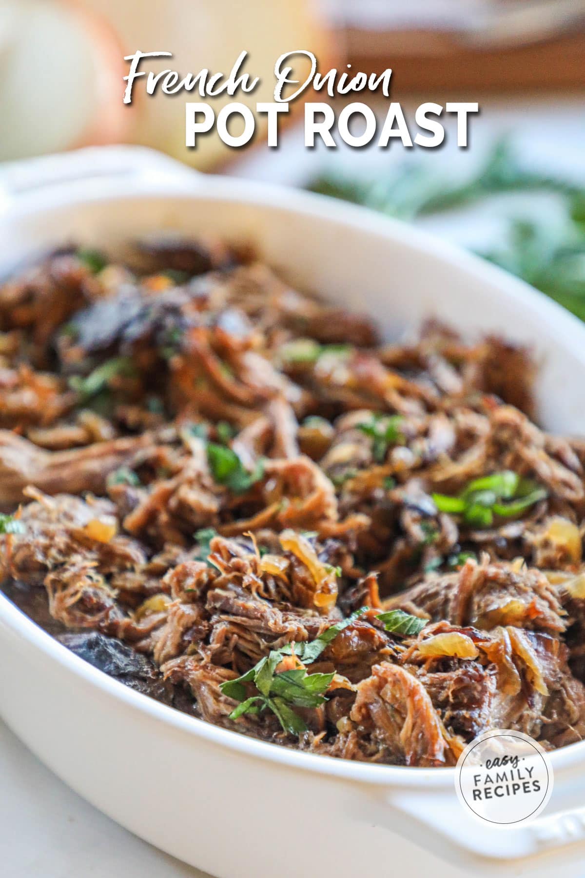 a casserole dish filled with shredded beef, onions, and parsley.