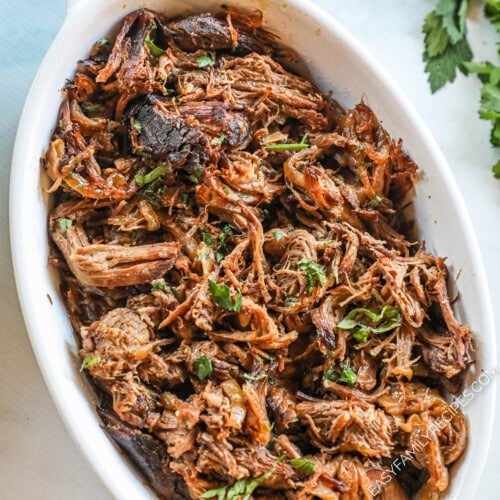 Slow Cooker French Onion Pot Roast shredded and placed in a serving dish.