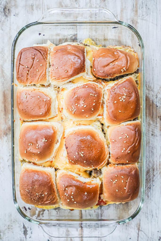 How to make cheeseburger sliders step 4: Place tops on the sliders and bake until cheese is melted.