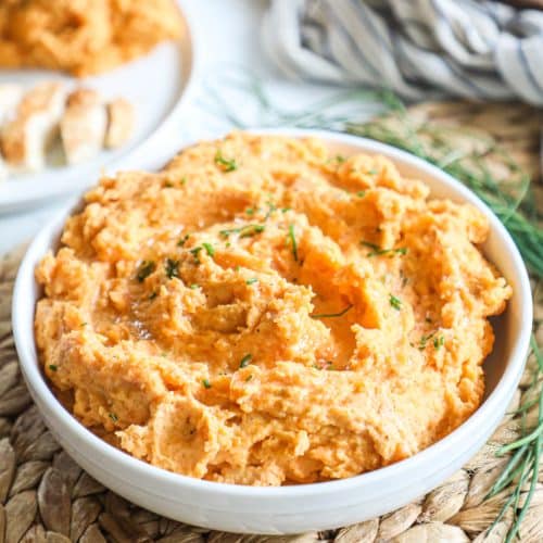 overhead of a bowl piled with mashed sweet potatoes.