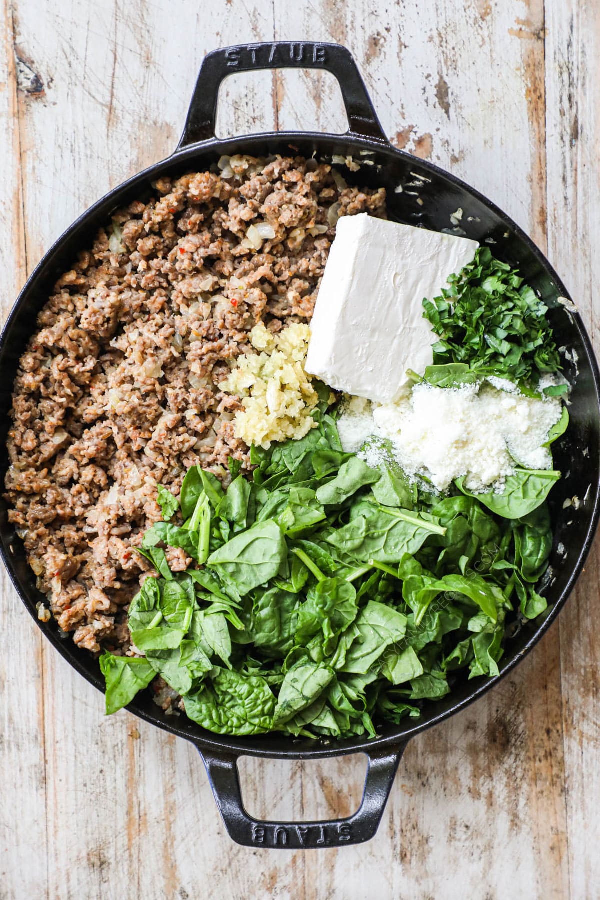 Stir in the cream cheese, parmesan and garlic until melted and creamy. Add the spinach and parsley and stir to combine.