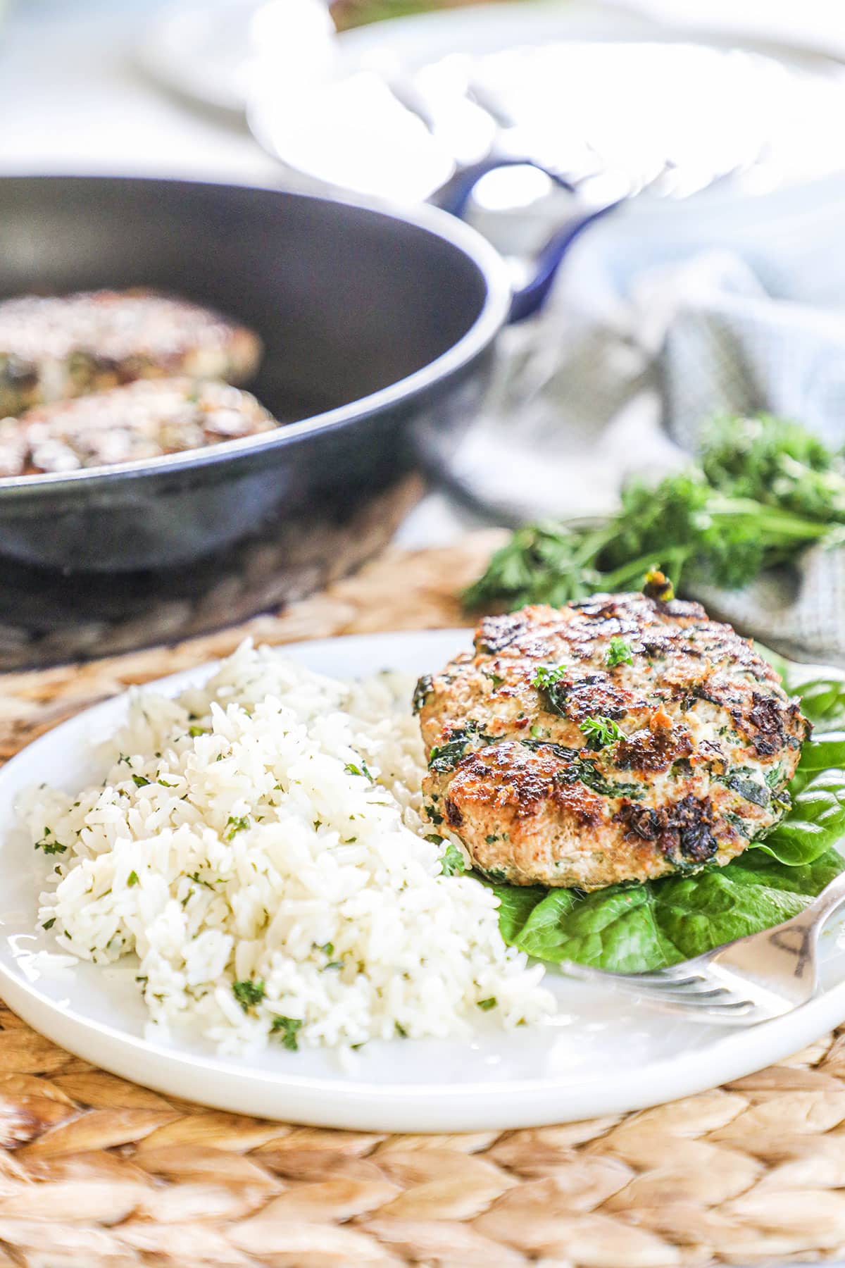 a plate piled with lemon herb rice, lettuce, and grilled chicken.