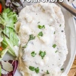 Cream of Mushroom Pork Chops served with salad on a plate.