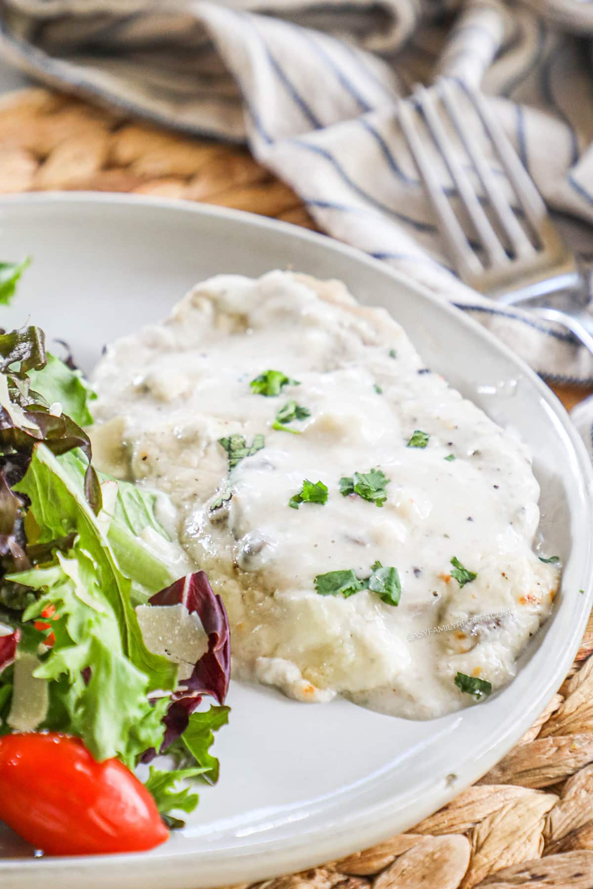 Plate of Cream of Mushroom Pork Chops served with salad.