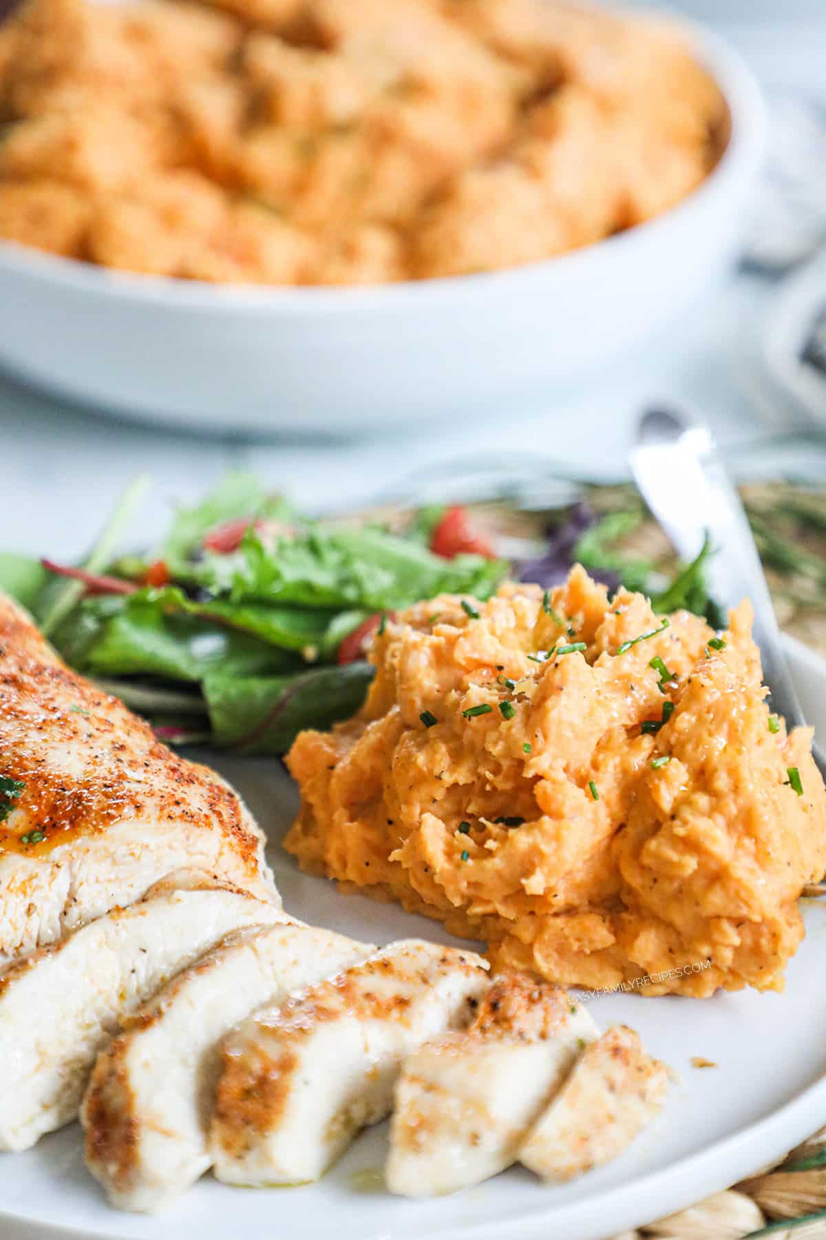 Savory mashed sweet potatoes served with turkey and salad.