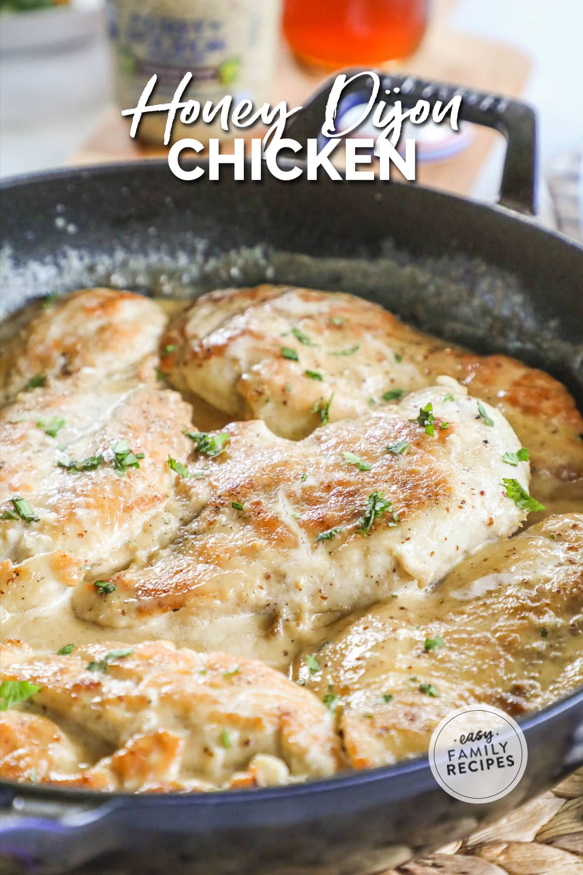 A pan of chicken simmered in a creamy Dijon mustard sauce.