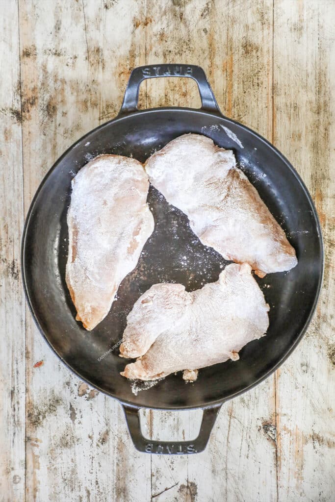 How to Make Dijon Chicken Step 1: Dredge thin chicken breast pieces in flour and sear on each side in the skillet.