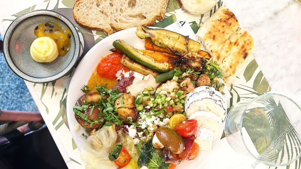 Israeli Breakfast plate filled with roasted vegetables, cheese, salad, and potatoes