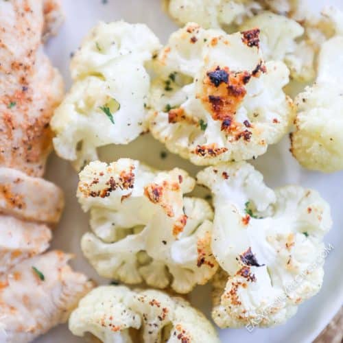 Golden brown parmesan roasted cauliflower on a plate.