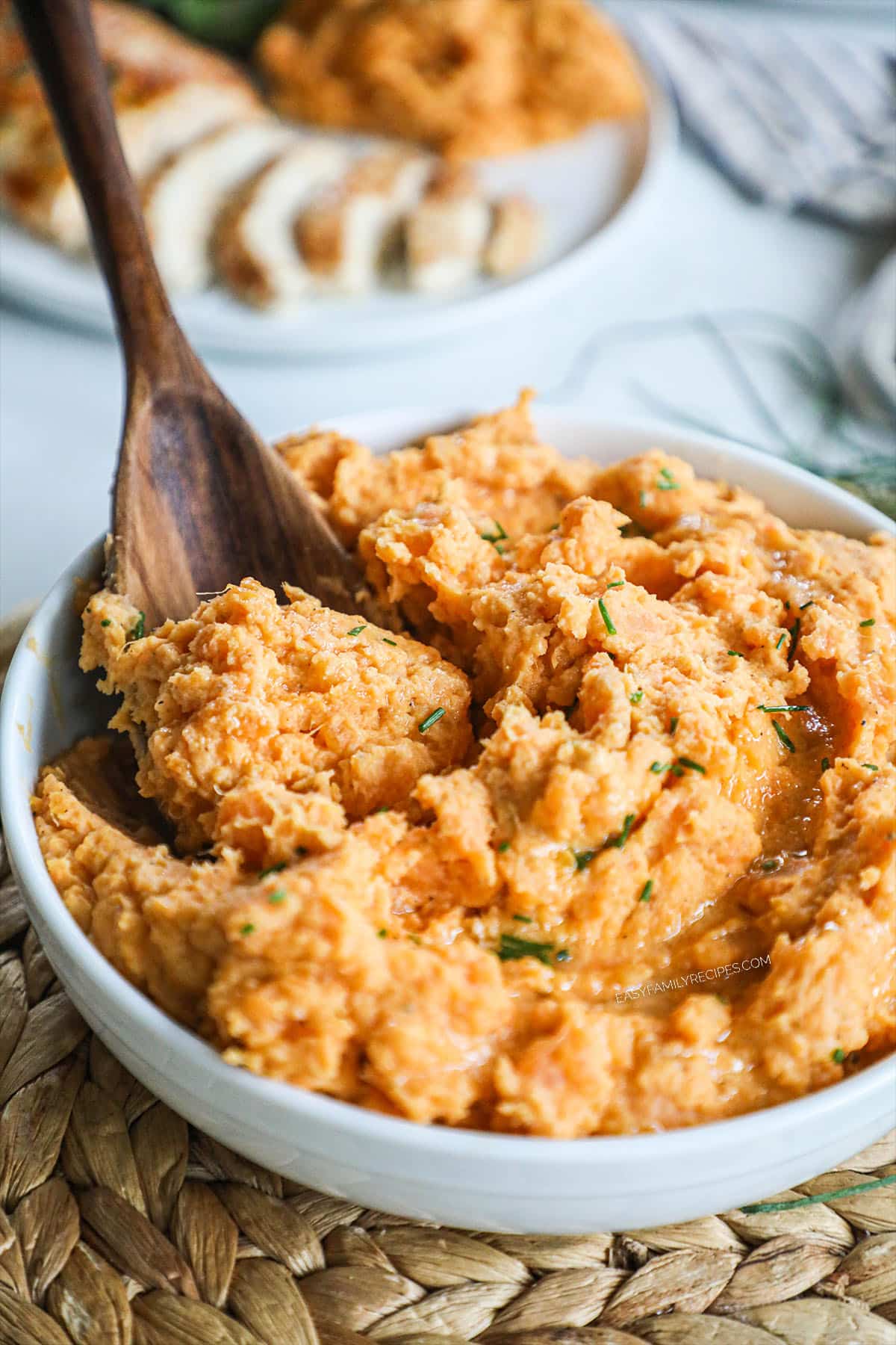 Mashed Sweet Potatoes with chives in a serving bowl.