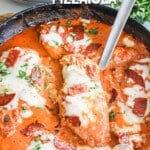 chicken breasts cooked in a skillet with tomato sauce and pepperoni pieces