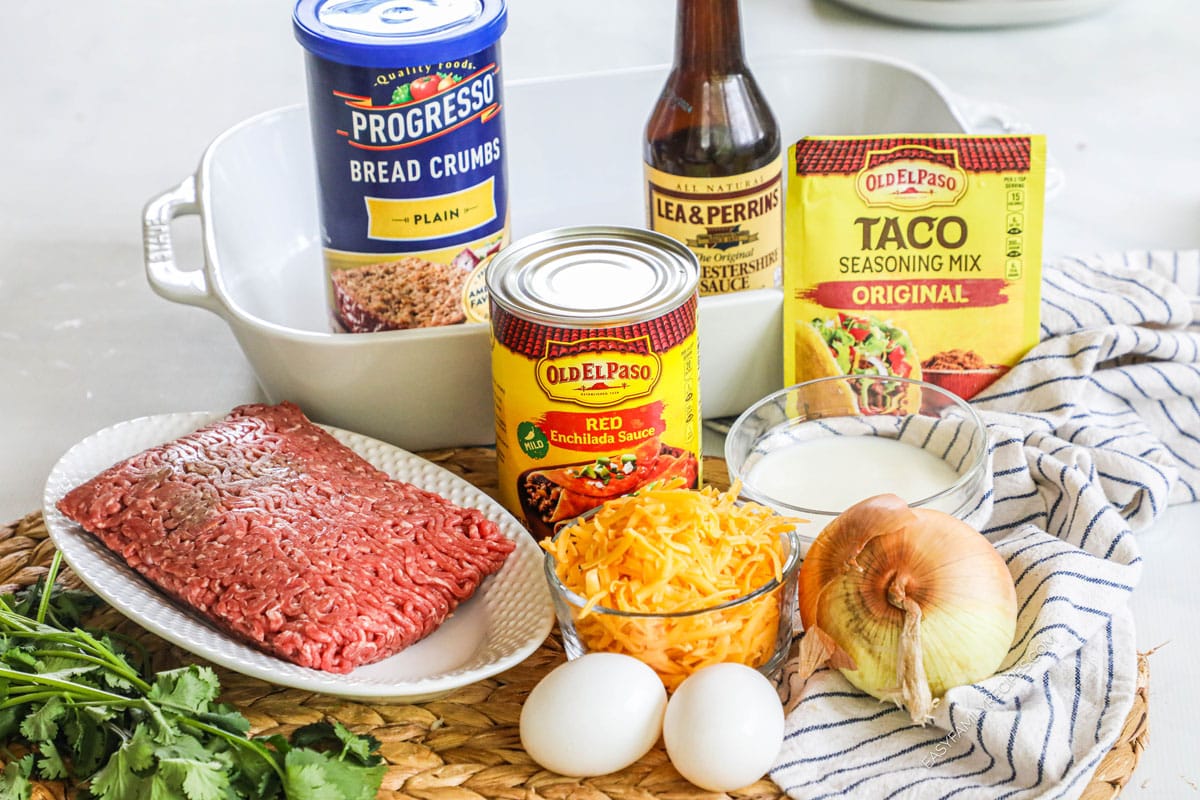 Ingredients for recipe in original packaging:; ground beef, breadcrumbs, enchilada sauce, Worcestershire sauce, taco seasoning, shredded cheese, milk, eggs, and onion.