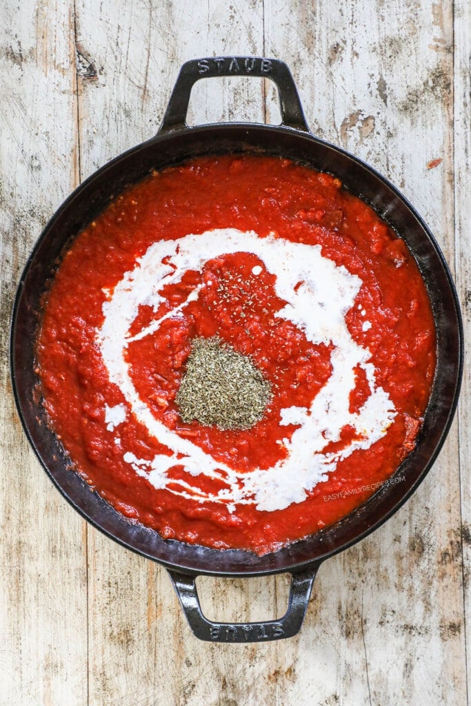 tomatoes and seasonings and cream in a skillet