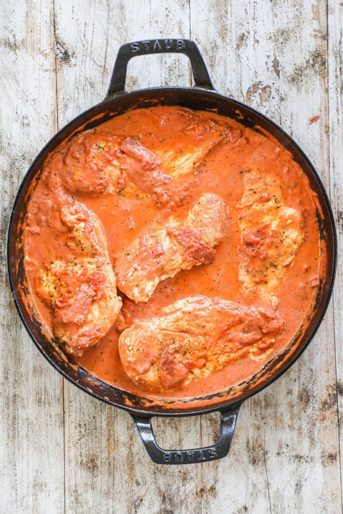 Once combined, add the chicken and juices back into the sauce and simmer until chicken is done