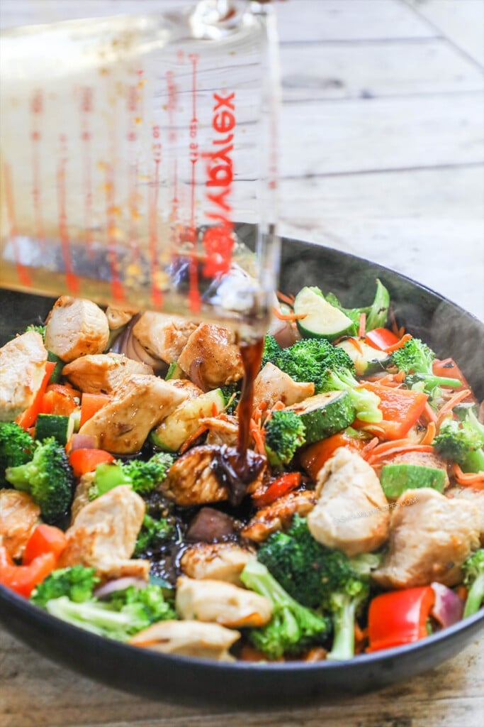 How to make chicken stir fry step 4: Pour the stir fry sauce over the chicken and vegetables and simmer until it thickens.