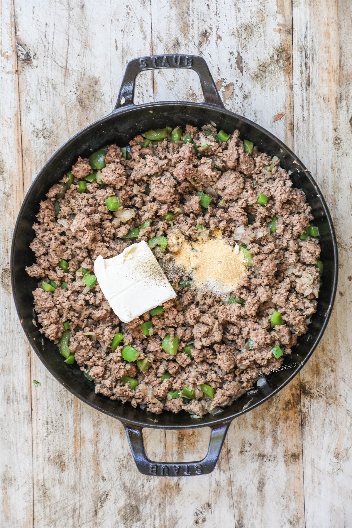 How to make philly cheesesteak sliders - step 2 - Stir in the garlic powder, salt, pepper, and onion powder. Then mix in the cream cheese until combined.