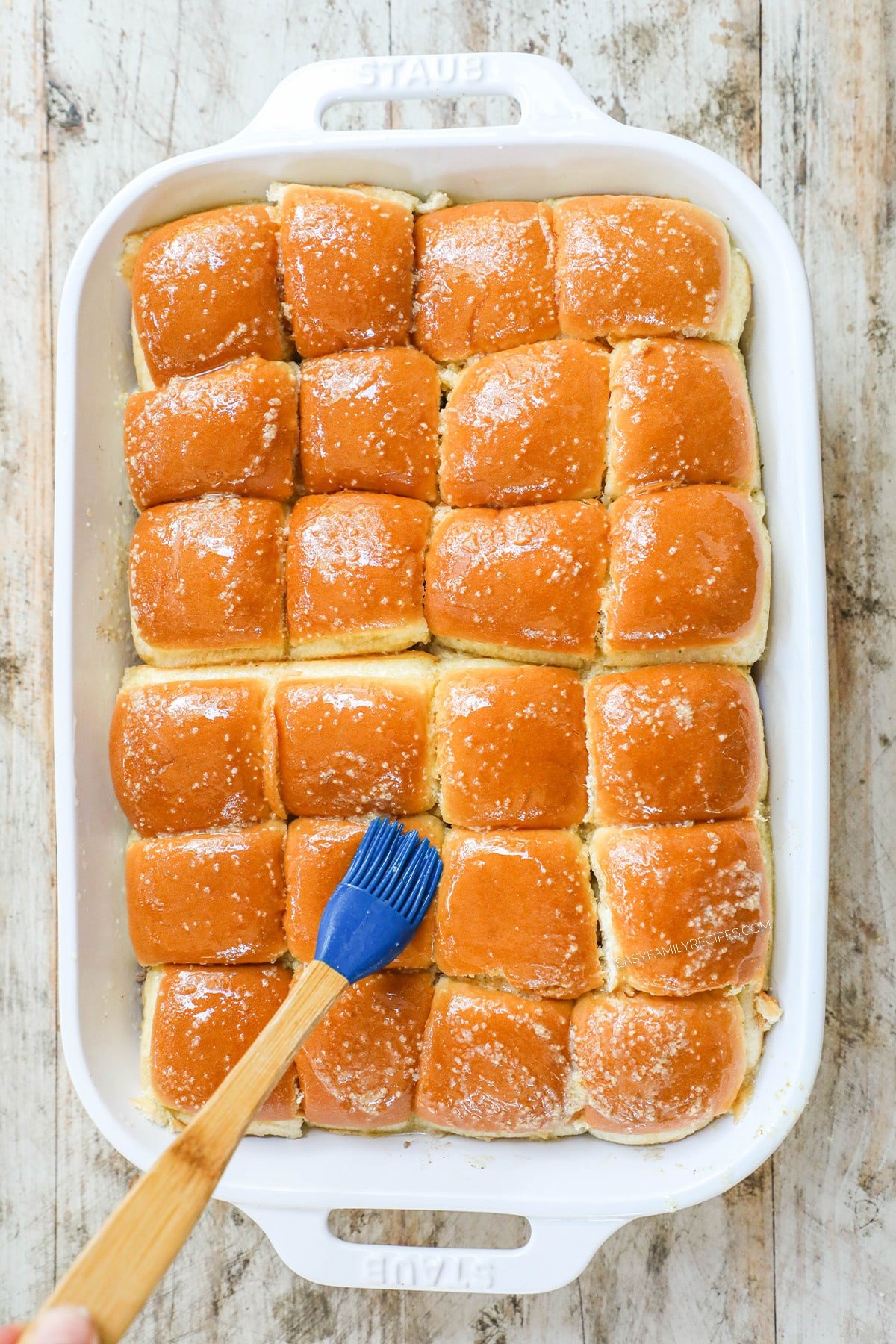 How to make philly cheesesteak sliders - step 5 - add top of rolls and cover with butter mixture