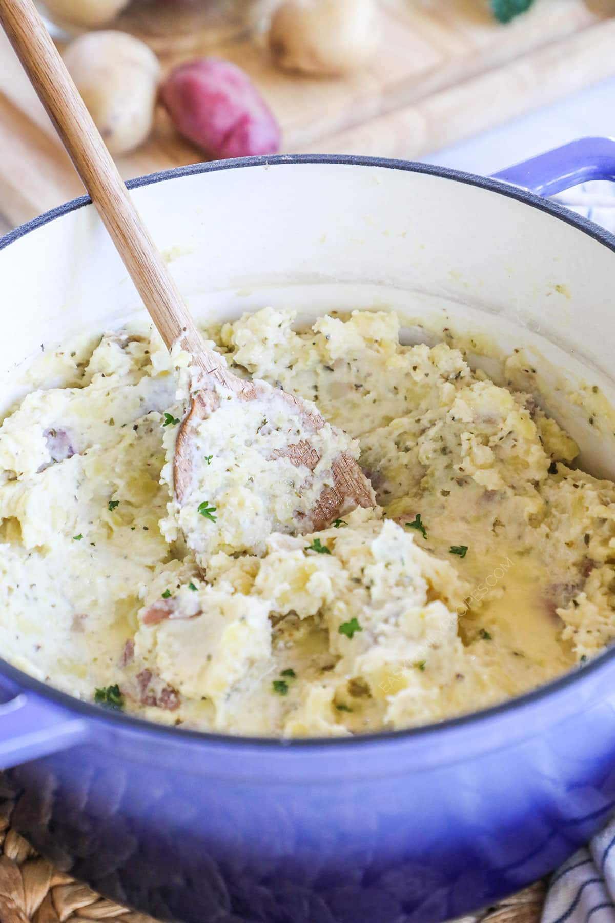 A large stove pot full of finished garlic parmesan mashed potatoes