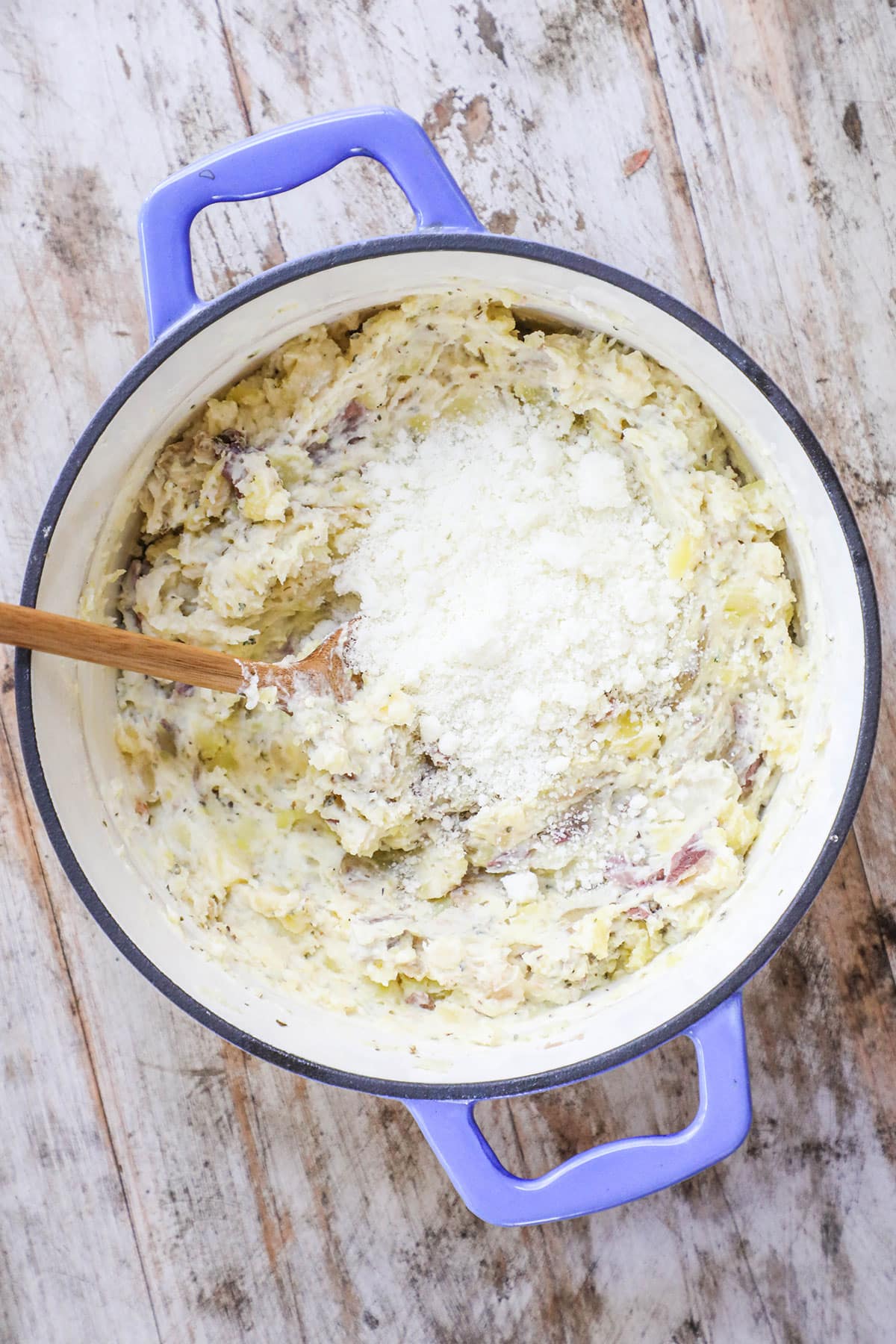 Stir in the grated parmesan, then stir in milk until the potatoes reach your desired consistency.