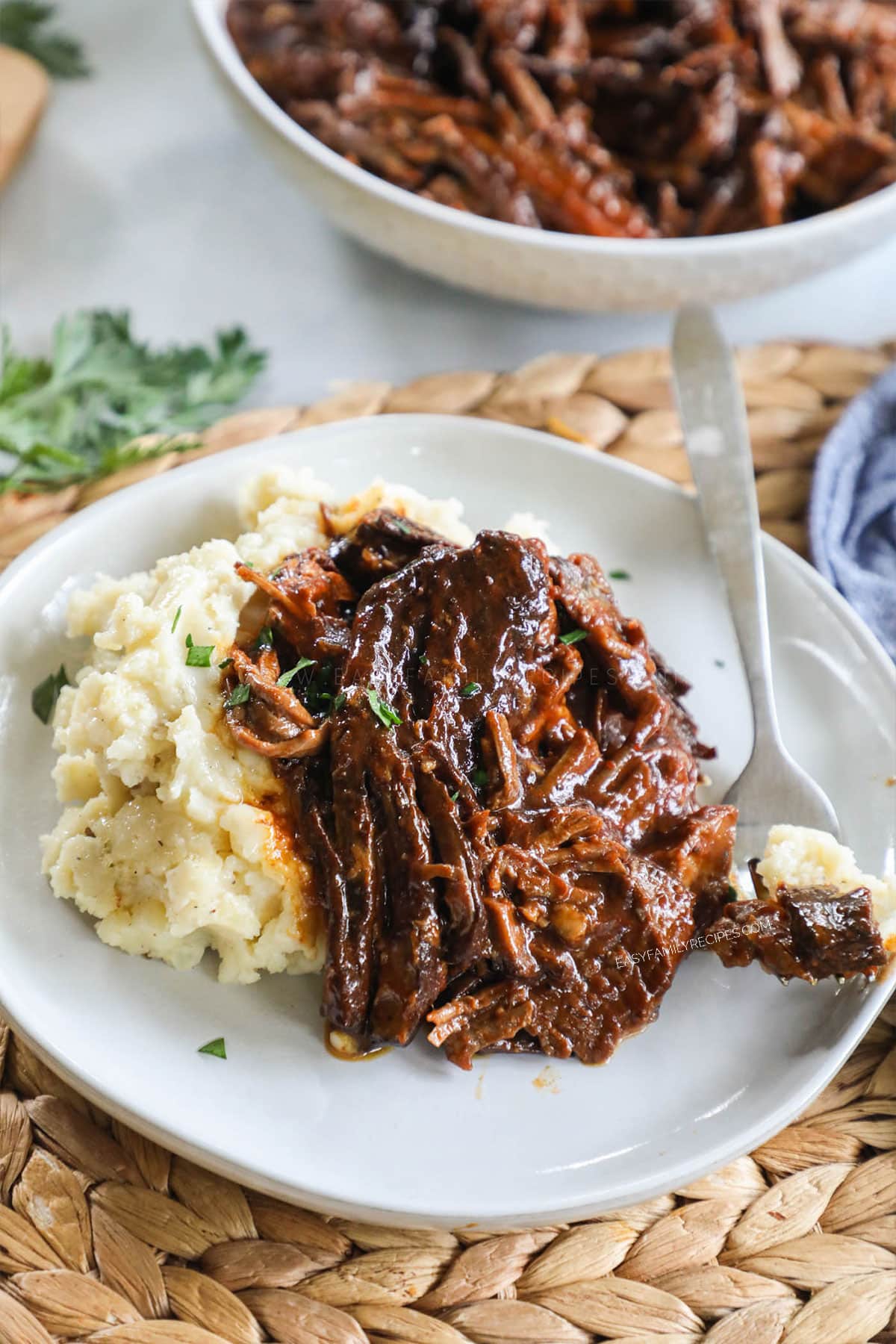 Beef Brisket made in crockpot served with potatoes on a plate