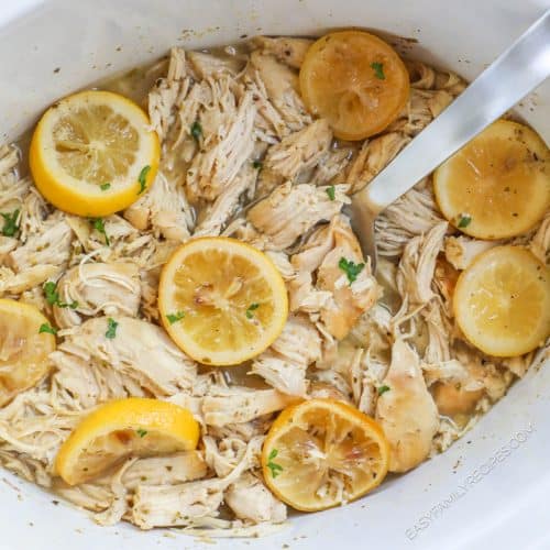 Overhead view of lemonade chicken in crockpot with serving spoon