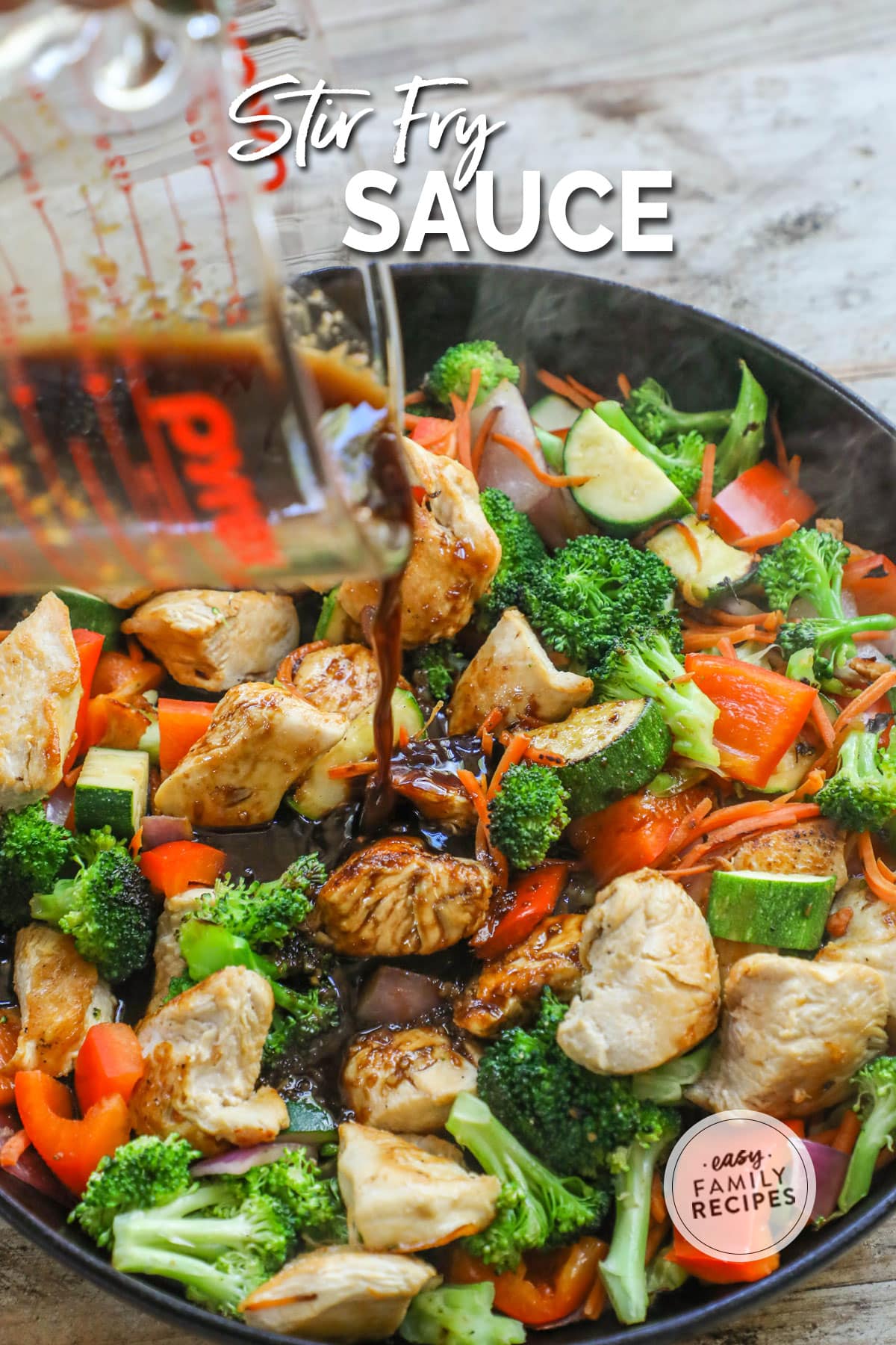 Adding stir fry sauce to a pan of hot chicken and asian style vegetables