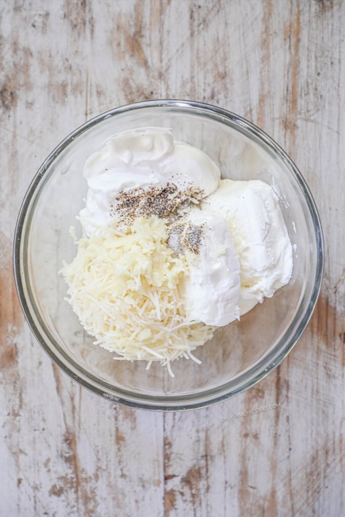 How to make Creamy Garlic Pork Chops Step 1- Combine cream cheese, sour cream, seasonings, and parmesan cheese in a mixing bowl.