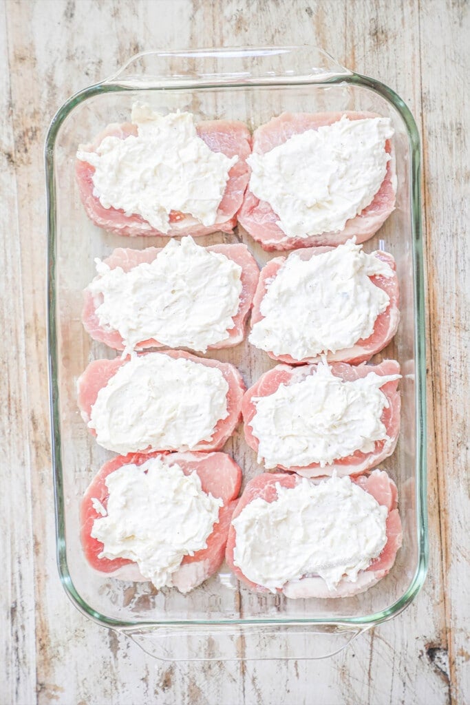 How to make Creamy Garlic Pork Chops Step 2- Spread cream cheese mixture over pork chops in a large baking dish.