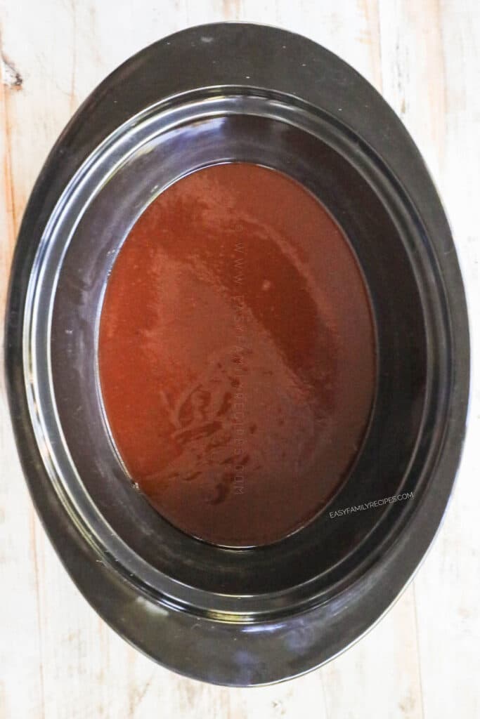 Step 2 for BBQ Brisket. Combine the barbecue sauce and broth in the bottom of the crock pot and mix.