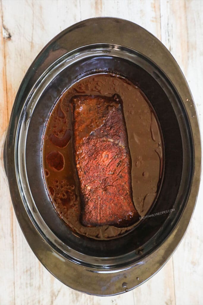 Step 4 to make BBQ Brisket - Cover and cook on low for 6-8 hours or until the meat is tender and cooked through.