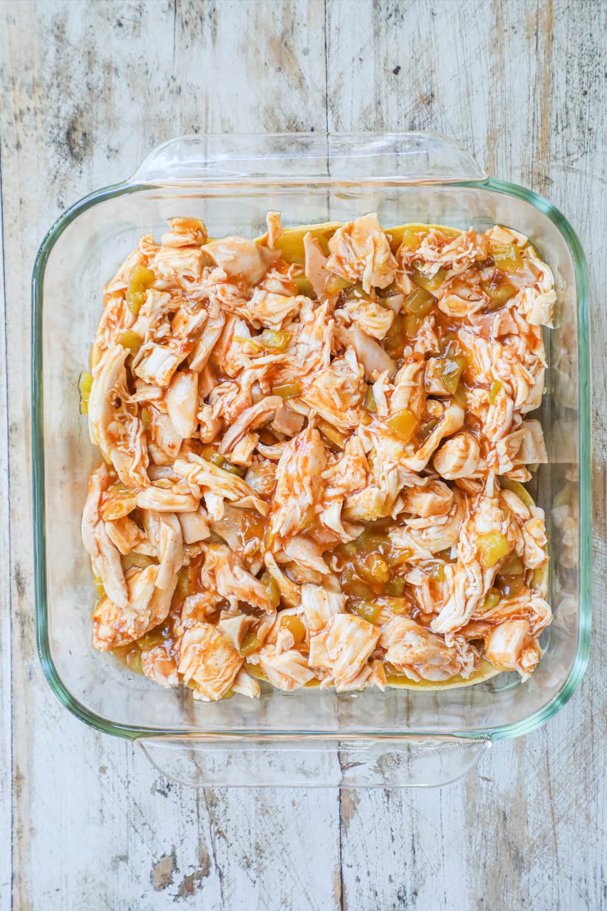 How to make chicken enchilada casserole step 2: Spread chicken mixture over tortillas.