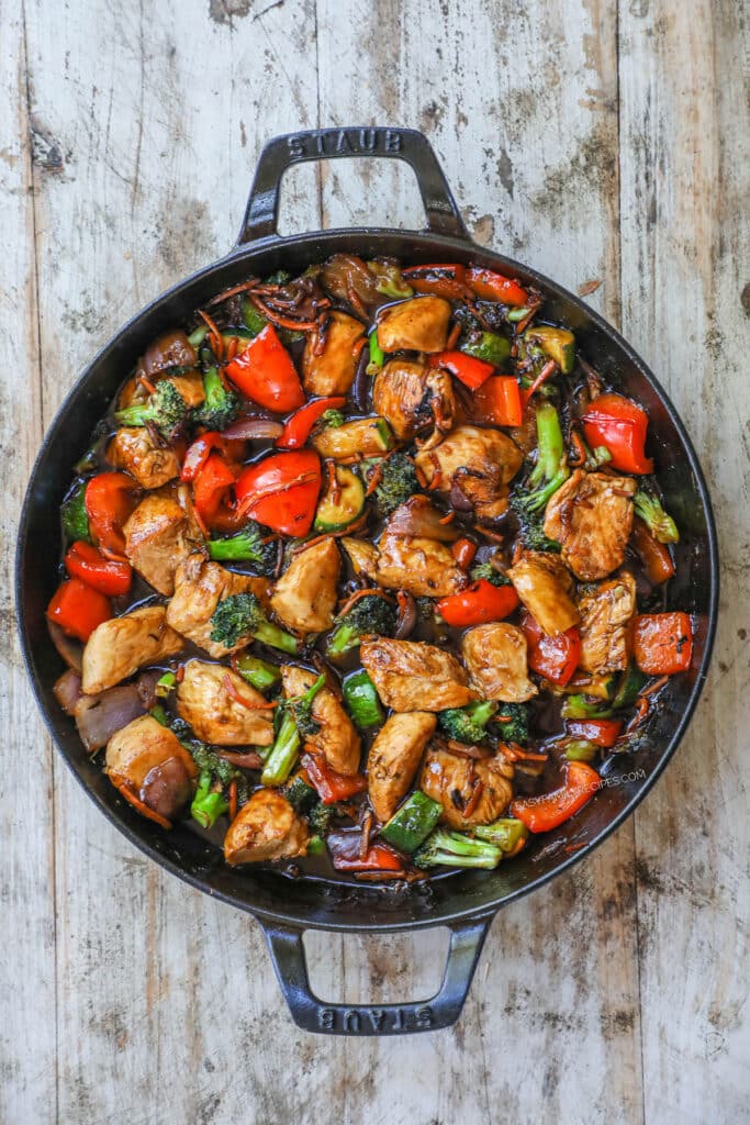 Stir fry sauce coating stir fry in pan.