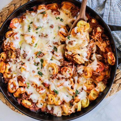 Overhead view of baked tortellini casserole in skillet