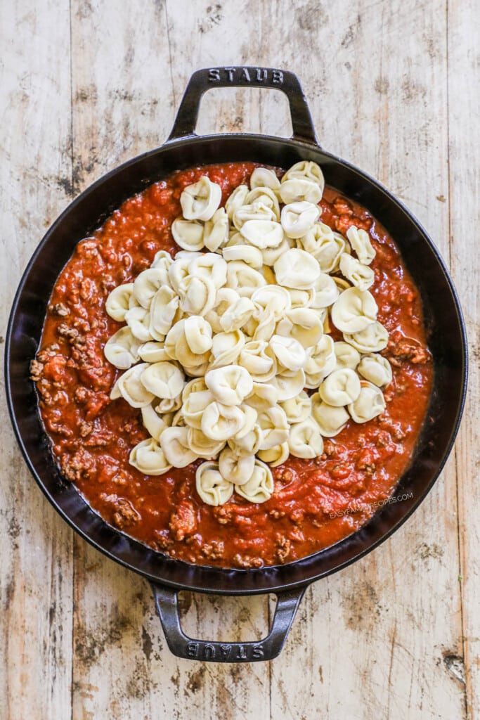 How to make Baked Tortellini Casserole Step 2: Add frozen cheese tortellini and mix.