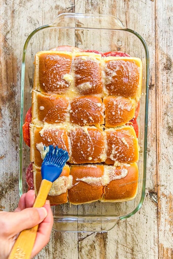 How to make Italian Grinder Sliders Step 5: brush glaze on the top of the rolls and bake.