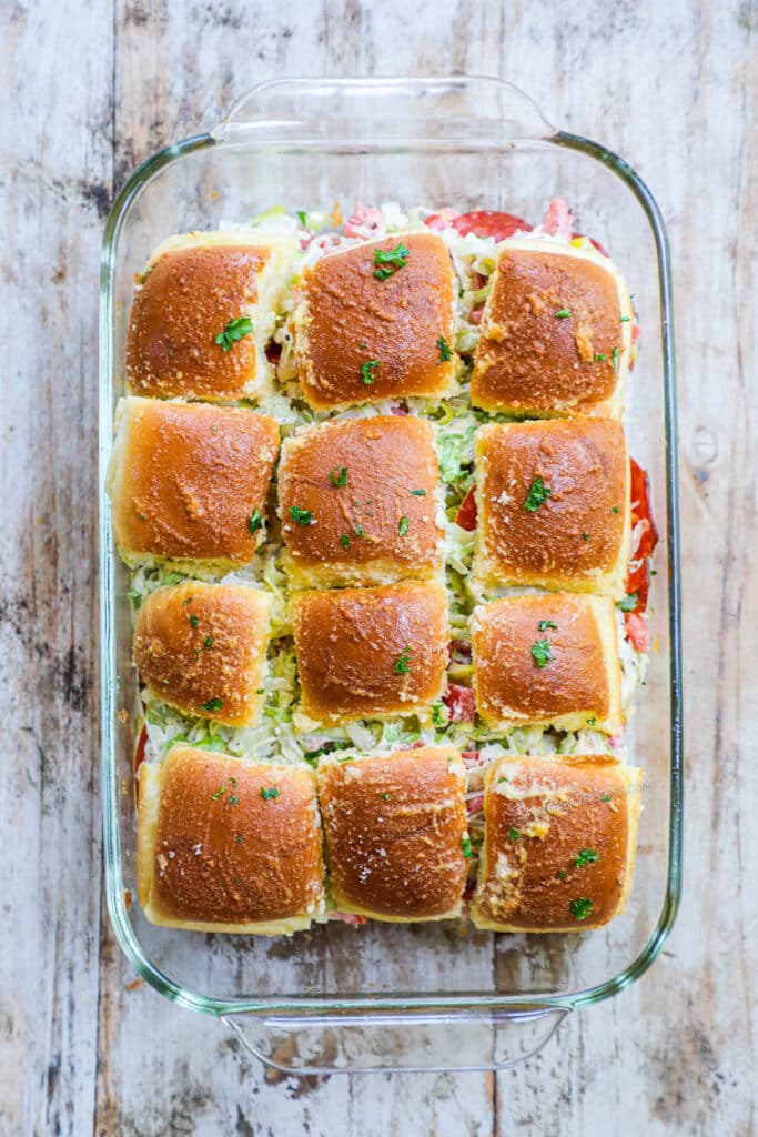 How to make Italian Grinder Sliders Step 6: Top rolls with salad mixture and replace tops. Serve immediately.