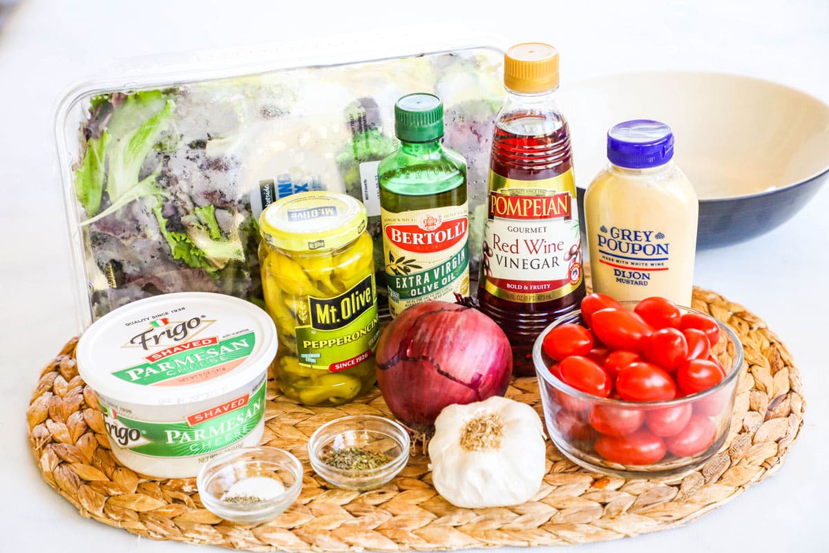 Ingredients for Italian House Salad, including grape tomatoes, spring mix, pepperoncini, garlic, shaved parmesan, and more