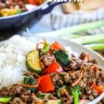 Lean ground beef stir fry on a plate with zucchini and rice.