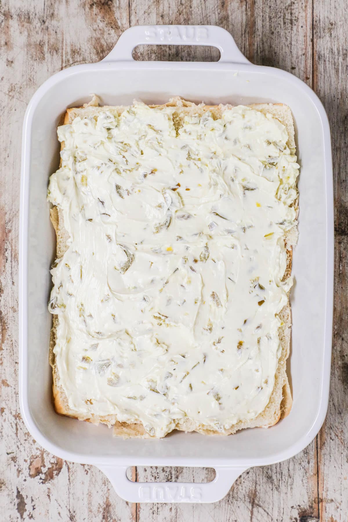 How to make Jalapeno Popper Chicken Sliders. 2. Spread mixture on rolls.