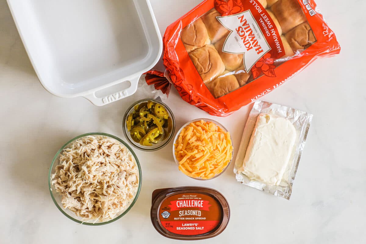 Ingredients to make Jalapeno Popper Sliders- cream cheese, shredded chicken, jalapeno peppers, cheddar cheese, lowerys seasoning salt, challenge butter