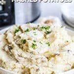 A bowl full of fluffy garlic parmesan mashed potatoes piled high