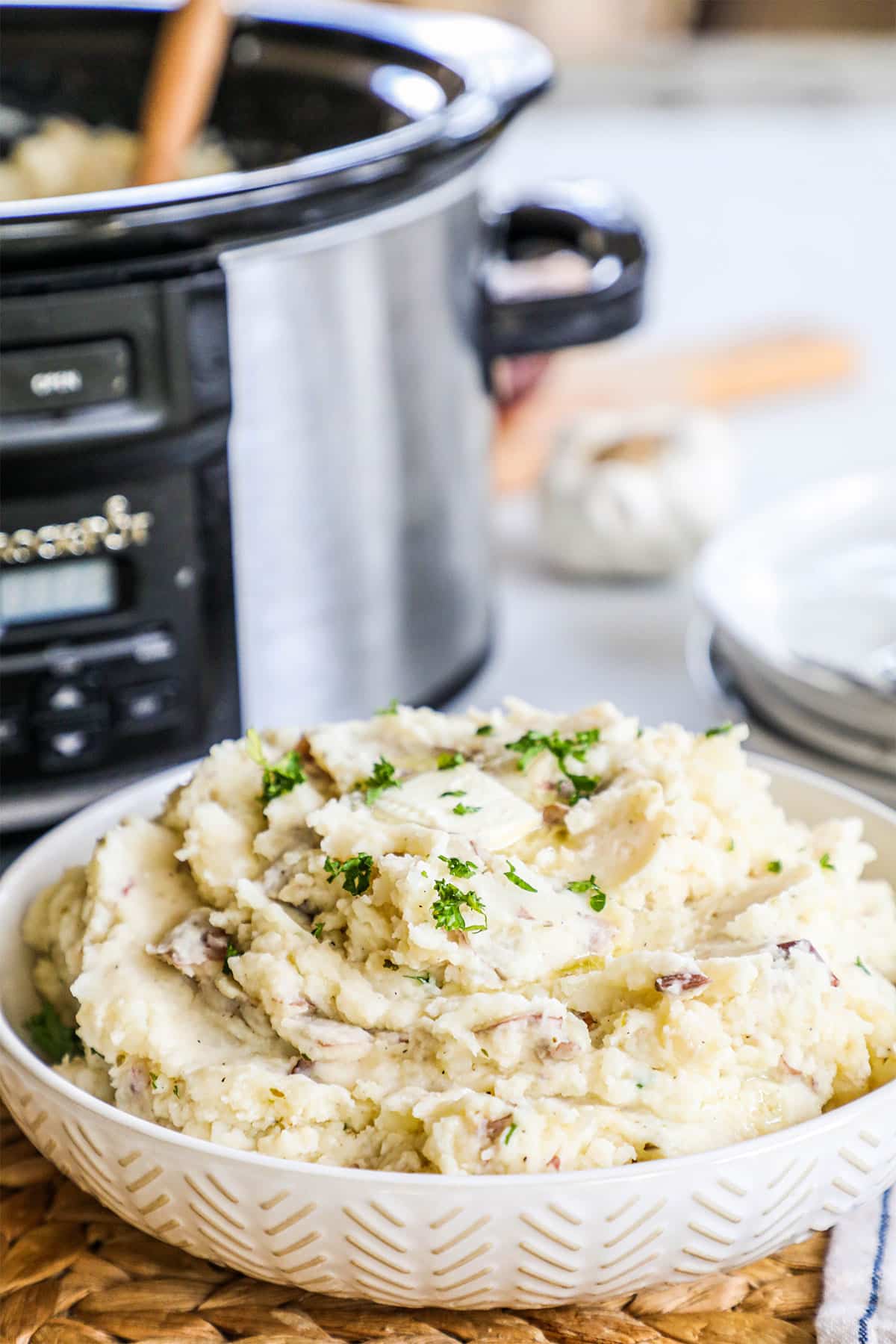 A bowl full of fluffy garlic parmesan mashed potatoes piled high