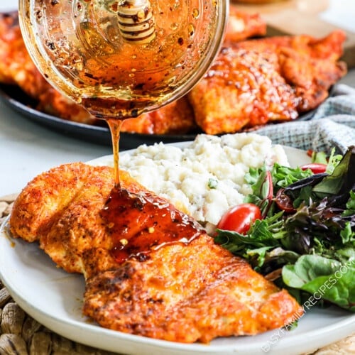 Hot Honey being drizzled over chicken.