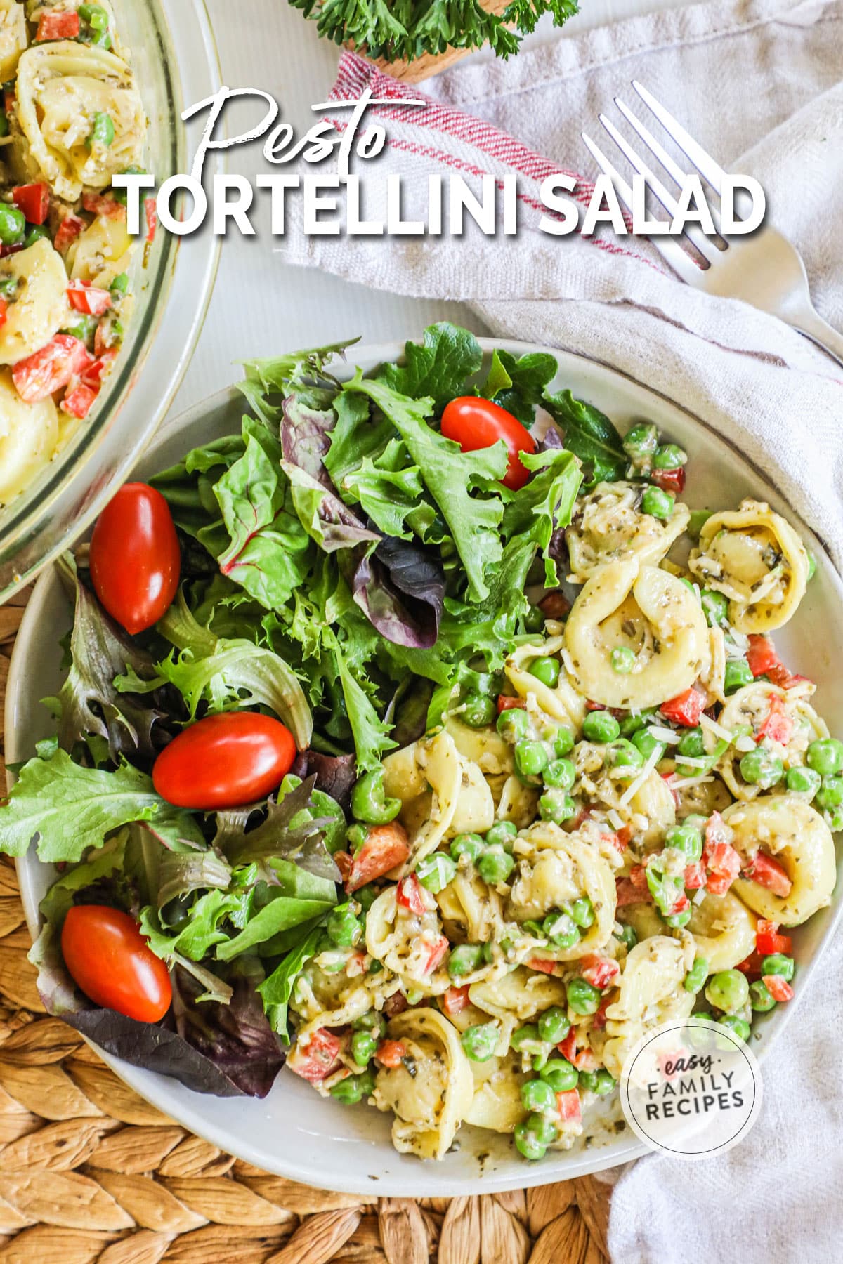 overhead of a plate with pesto pasta salad and a green salad.