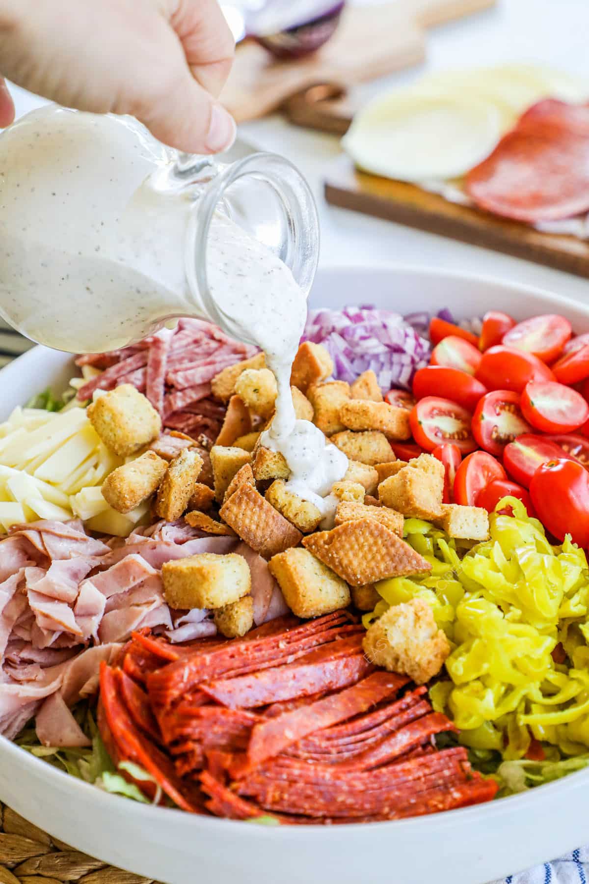 A large serving bowl with a grinder salad.