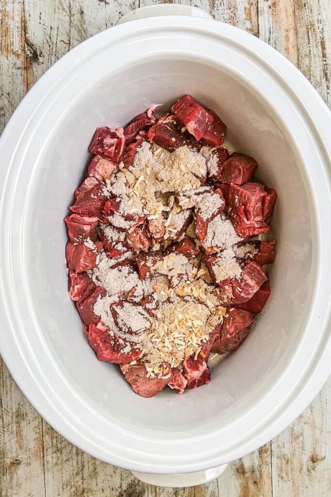 How to make crockpot steak bites step 2: Cover in onion soup and au jus gravy mix.